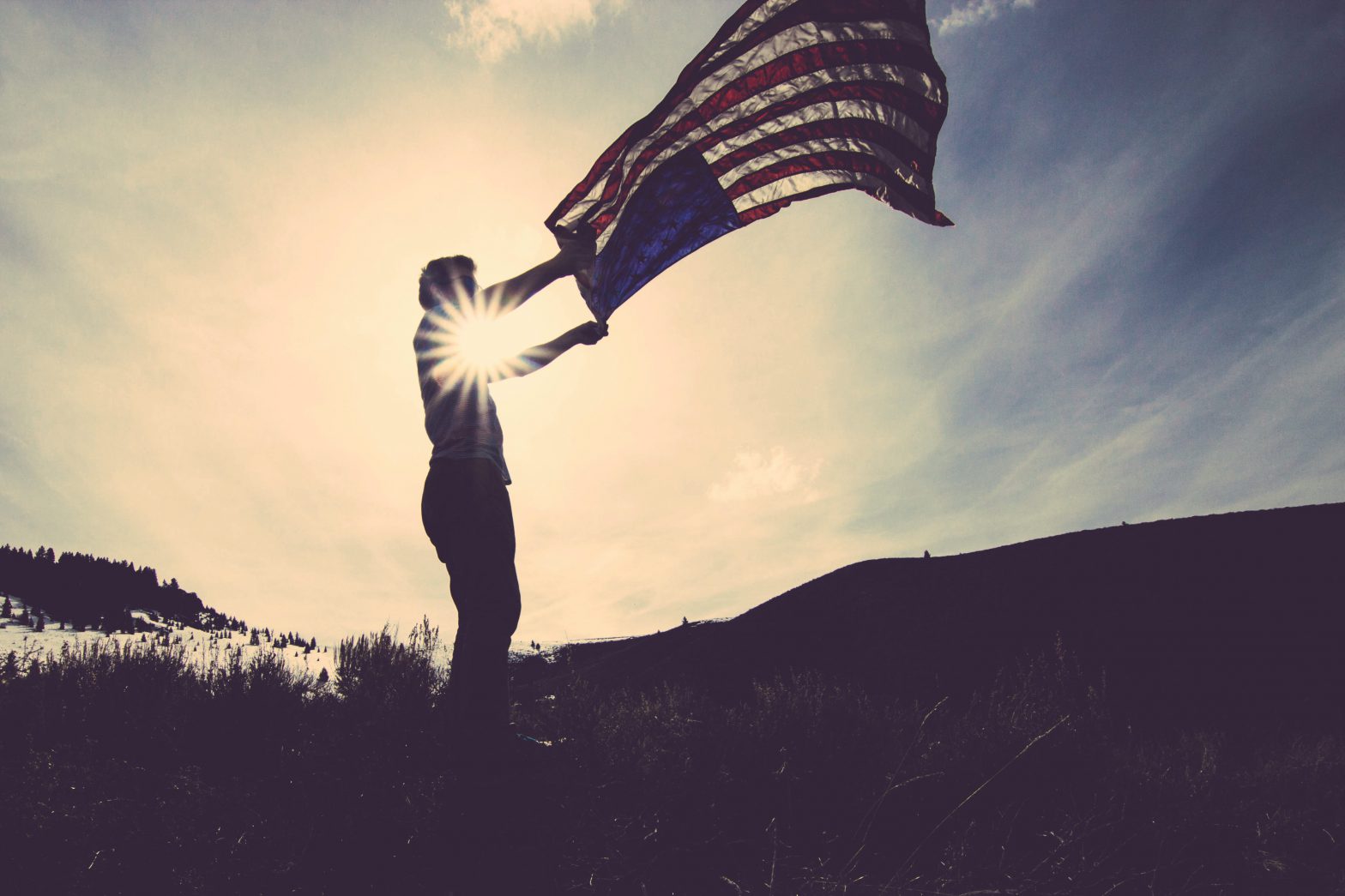 person holding an american flag outside